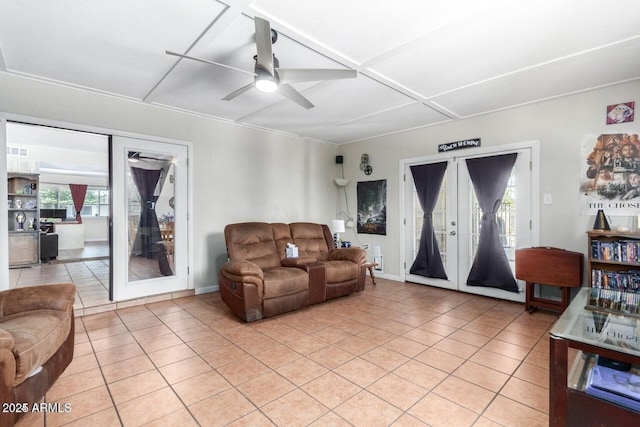 living room with french doors, ceiling fan, coffered ceiling, and light tile patterned floors