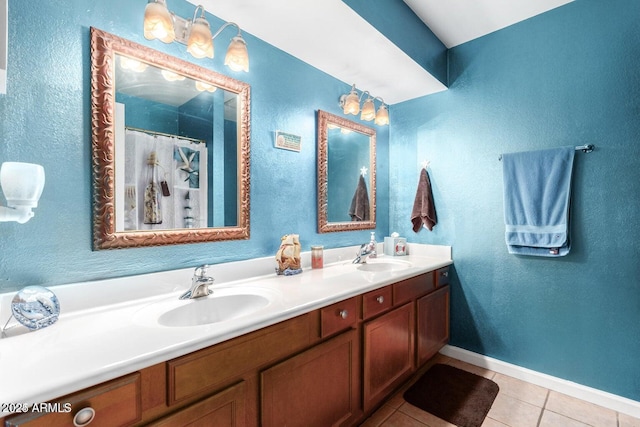 bathroom with vanity, curtained shower, and tile patterned floors