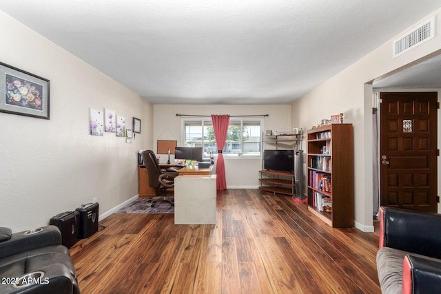 office space with dark wood-type flooring