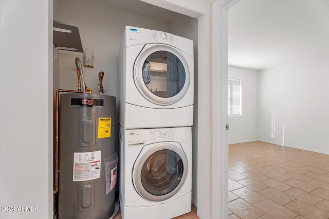 washroom with water heater and stacked washing maching and dryer