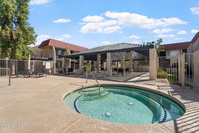 view of pool with a hot tub and a patio