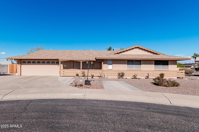 ranch-style home featuring an attached garage, brick siding, and driveway