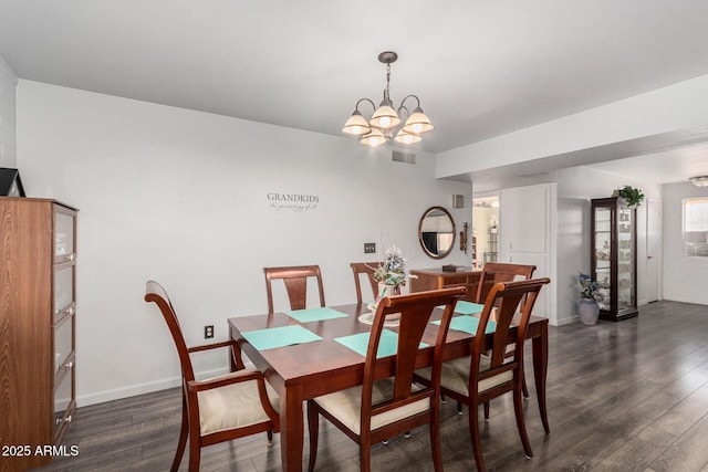 dining area with baseboards, dark wood-style floors, visible vents, and a chandelier