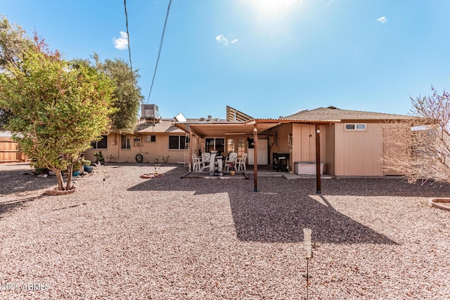 back of property with a patio area, fence, and central AC