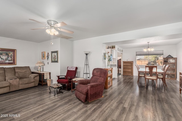 living room with visible vents, wood finished floors, and ceiling fan with notable chandelier