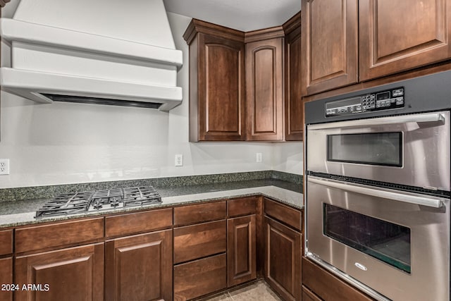 kitchen featuring appliances with stainless steel finishes and ventilation hood