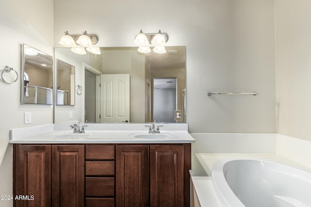 bathroom with vanity and a tub to relax in