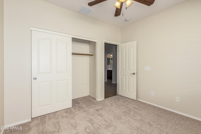 unfurnished bedroom featuring light carpet, ceiling fan, and a closet