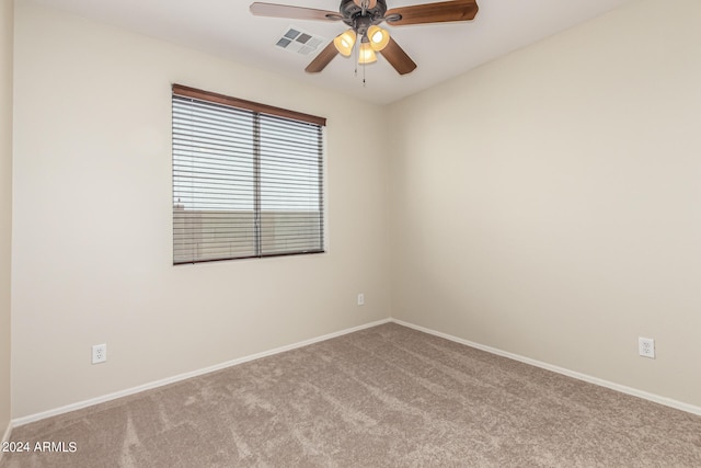 empty room with ceiling fan and light colored carpet