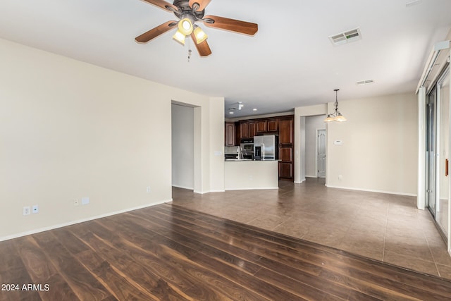 unfurnished living room featuring dark hardwood / wood-style floors and ceiling fan