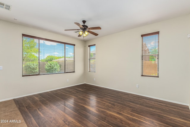 spare room with ceiling fan and dark hardwood / wood-style flooring