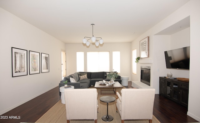 living room with an inviting chandelier and dark hardwood / wood-style floors