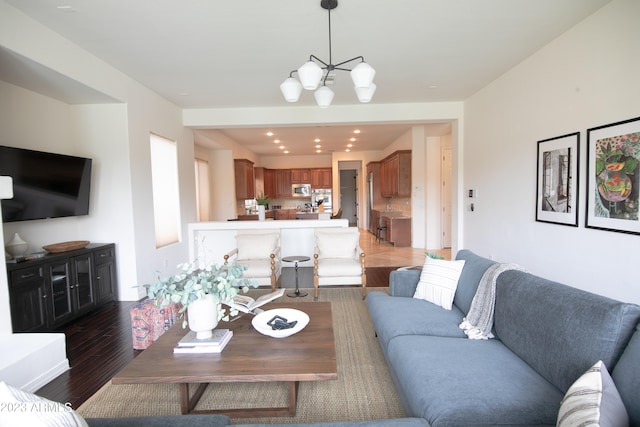 living room featuring a chandelier and dark hardwood / wood-style flooring