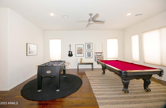 rec room with ceiling fan, a wealth of natural light, and dark hardwood / wood-style floors