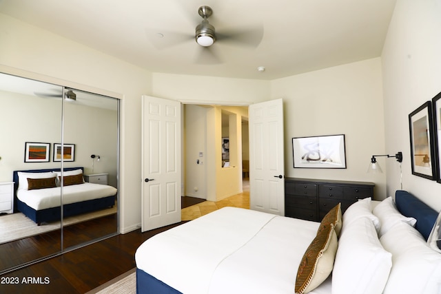 bedroom with ceiling fan, hardwood / wood-style flooring, and a closet