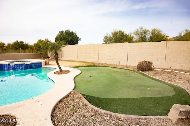 view of pool with an in ground hot tub