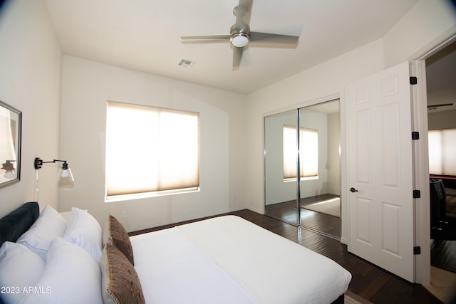 bedroom with ceiling fan, a closet, and dark hardwood / wood-style flooring