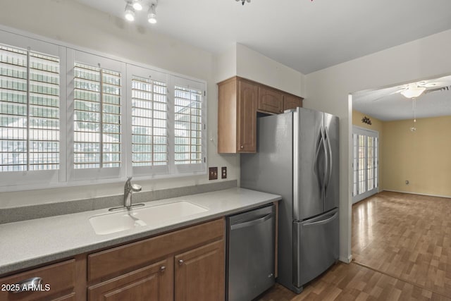 kitchen featuring visible vents, dark wood finished floors, stainless steel appliances, light countertops, and a sink