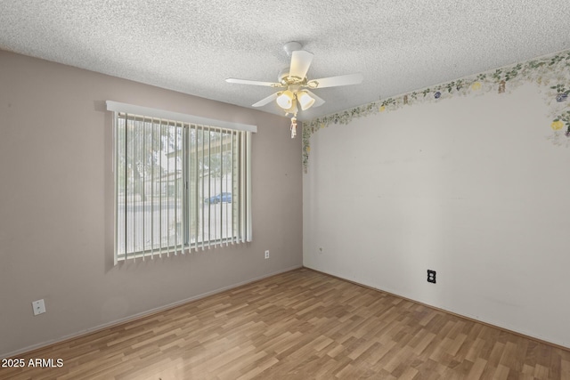 unfurnished room with a ceiling fan, a textured ceiling, and light wood finished floors