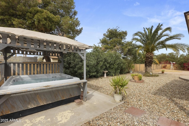 view of yard with fence and a hot tub