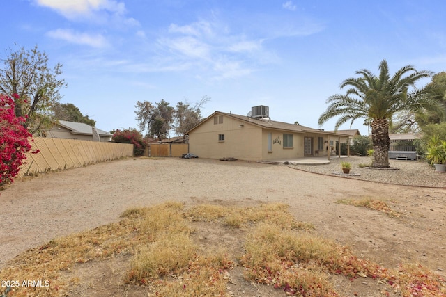 exterior space with driveway, a patio area, fence, and central AC