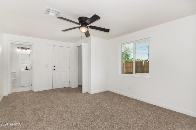 unfurnished bedroom with carpet flooring, ceiling fan, and a closet