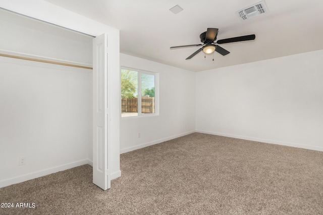 unfurnished bedroom with carpet flooring, a closet, ceiling fan, and ensuite bathroom