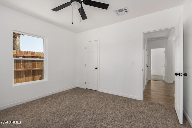 unfurnished bedroom featuring ceiling fan and carpet floors