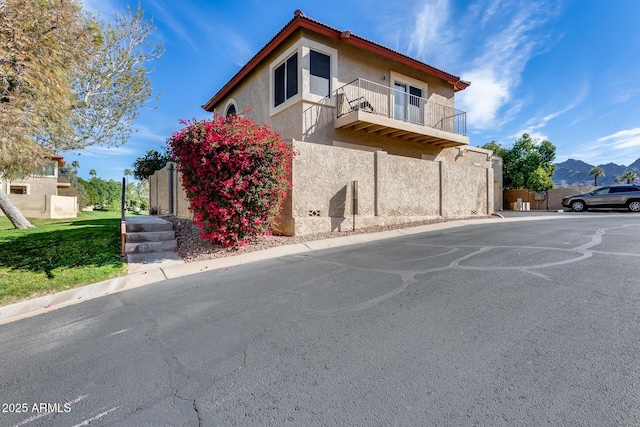 exterior space featuring a balcony and stucco siding