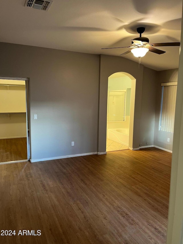 spare room with ceiling fan and wood-type flooring