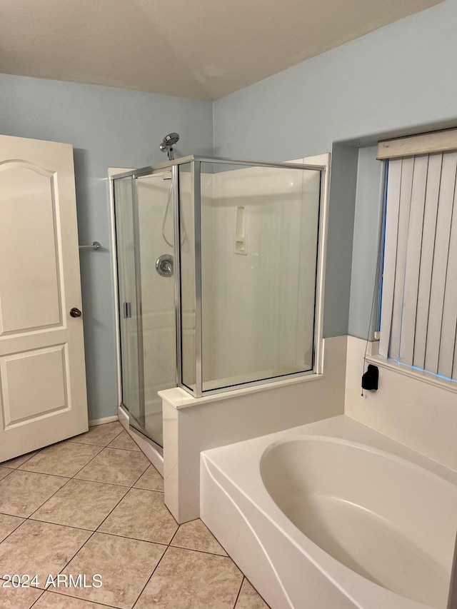 bathroom featuring tile patterned floors and independent shower and bath