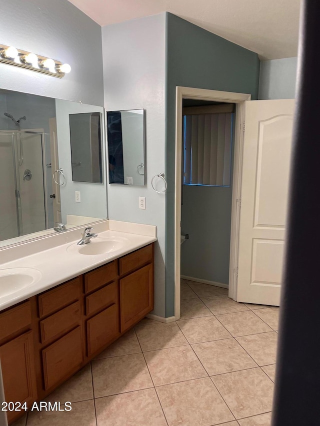 bathroom featuring vanity, tile patterned floors, and a shower with shower door