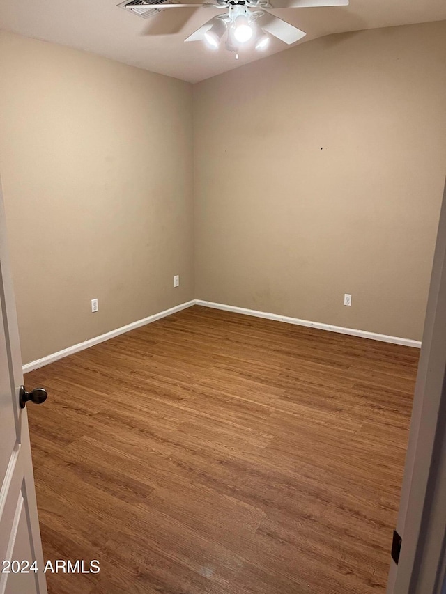 empty room with hardwood / wood-style floors and ceiling fan