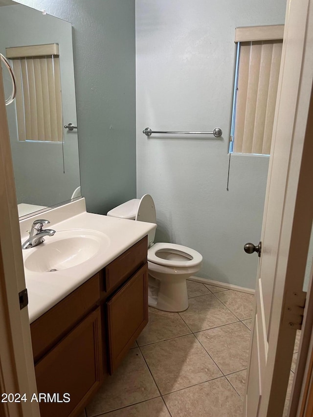 bathroom featuring toilet, vanity, and tile patterned floors