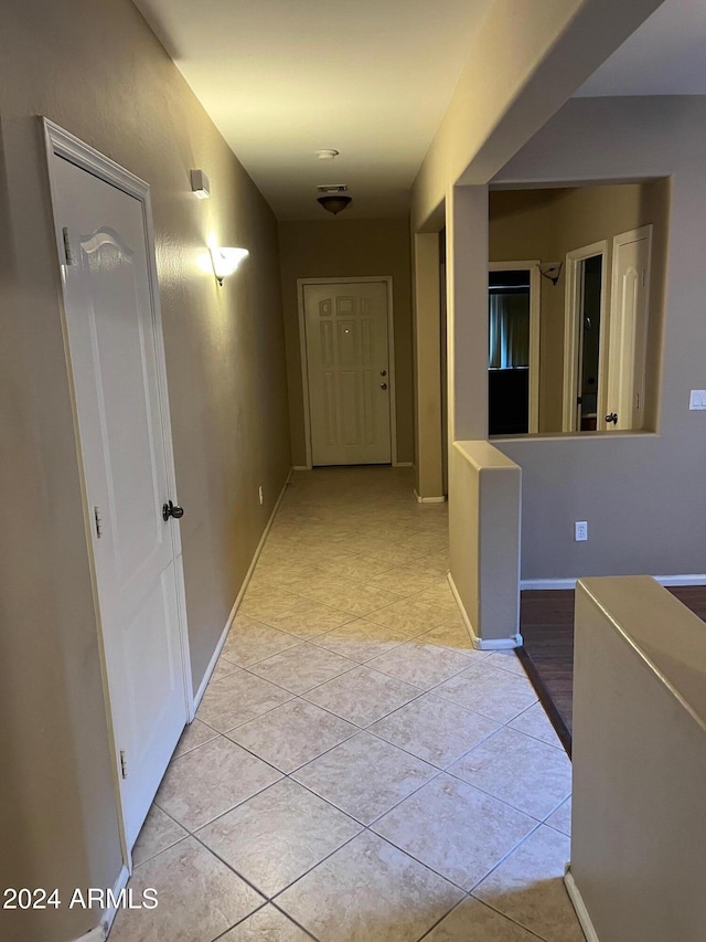 hallway featuring light tile patterned flooring