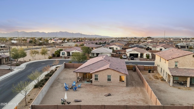 aerial view at dusk with a residential view and a mountain view