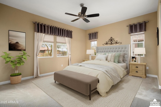 bedroom featuring baseboards, light carpet, and a ceiling fan