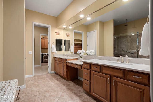 full bathroom with double vanity, washer / dryer, a stall shower, and a sink