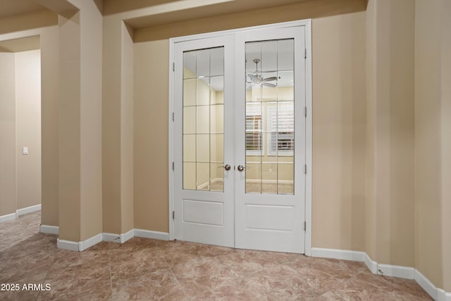 doorway featuring french doors and baseboards