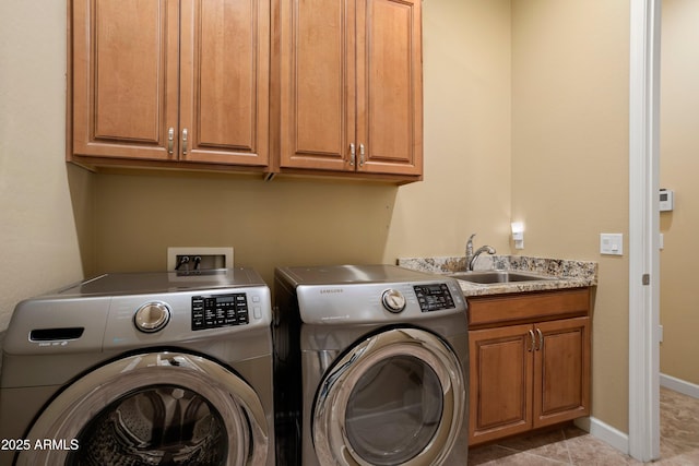 laundry area with baseboards, light tile patterned flooring, cabinet space, a sink, and washer and dryer