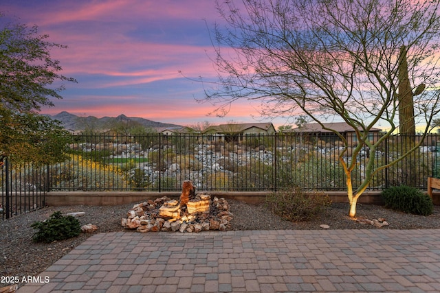 patio terrace at dusk with fence and a mountain view