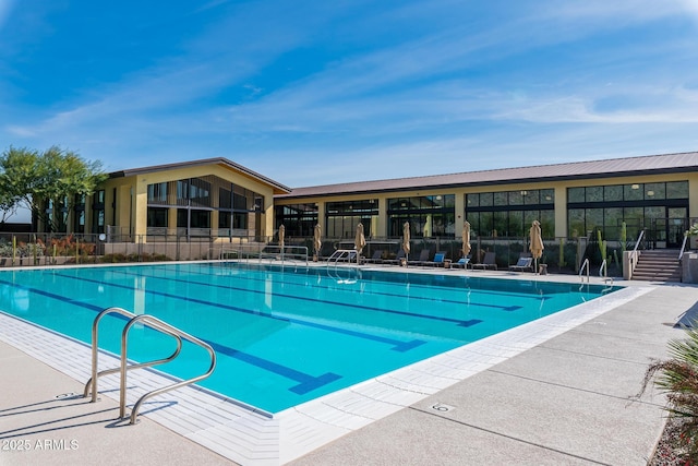 community pool featuring a patio area and fence