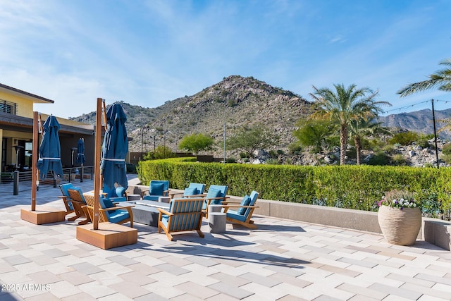 20584 W Hillcrest Blvd, Buckeye, AZ 85396 - view of patio / terrace featuring a mountain view and an outdoor fire pit