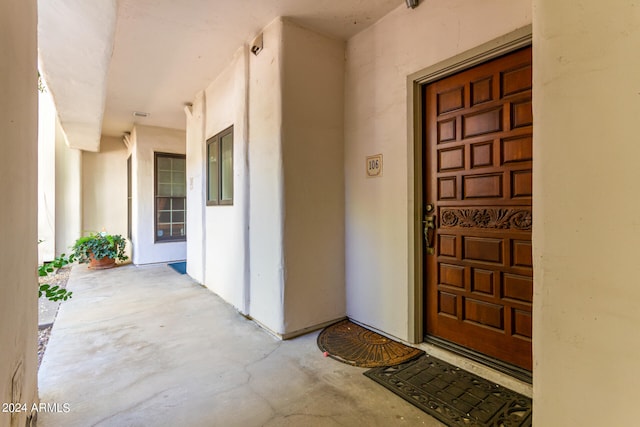 entrance to property featuring stucco siding