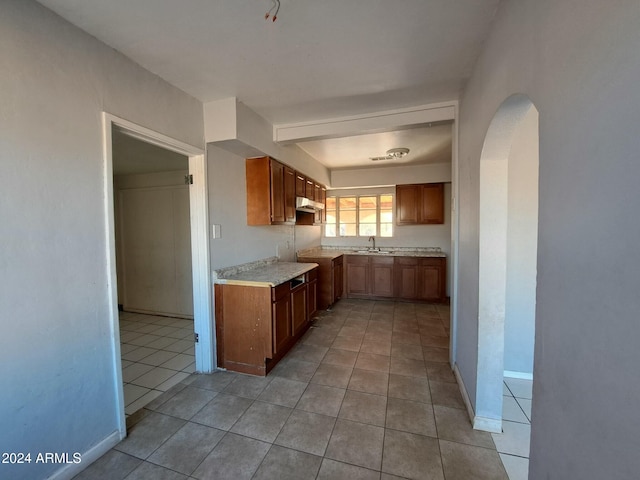 kitchen featuring light tile patterned floors and sink