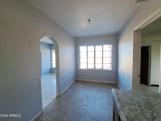 unfurnished dining area with light tile patterned floors