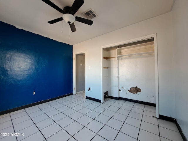 unfurnished bedroom with ceiling fan, a closet, and light tile patterned floors