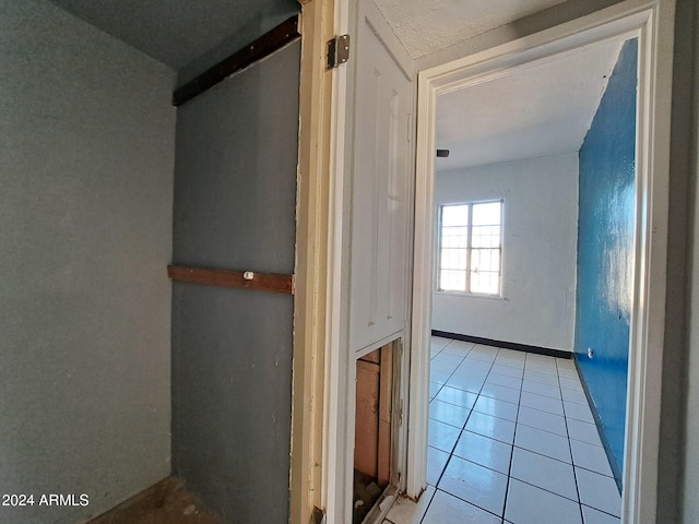 corridor featuring light tile patterned flooring