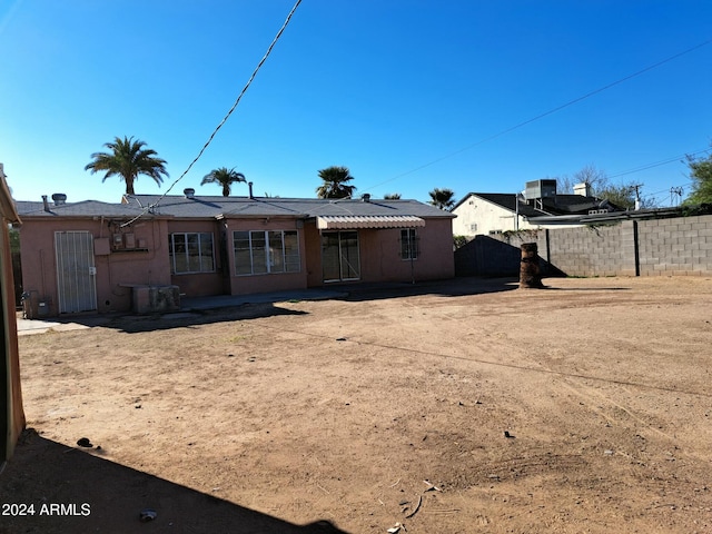 back of house featuring central AC