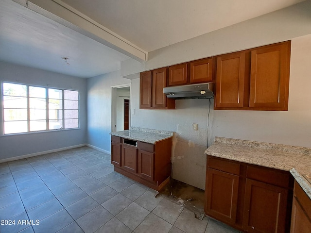 kitchen with light stone counters and light tile patterned floors